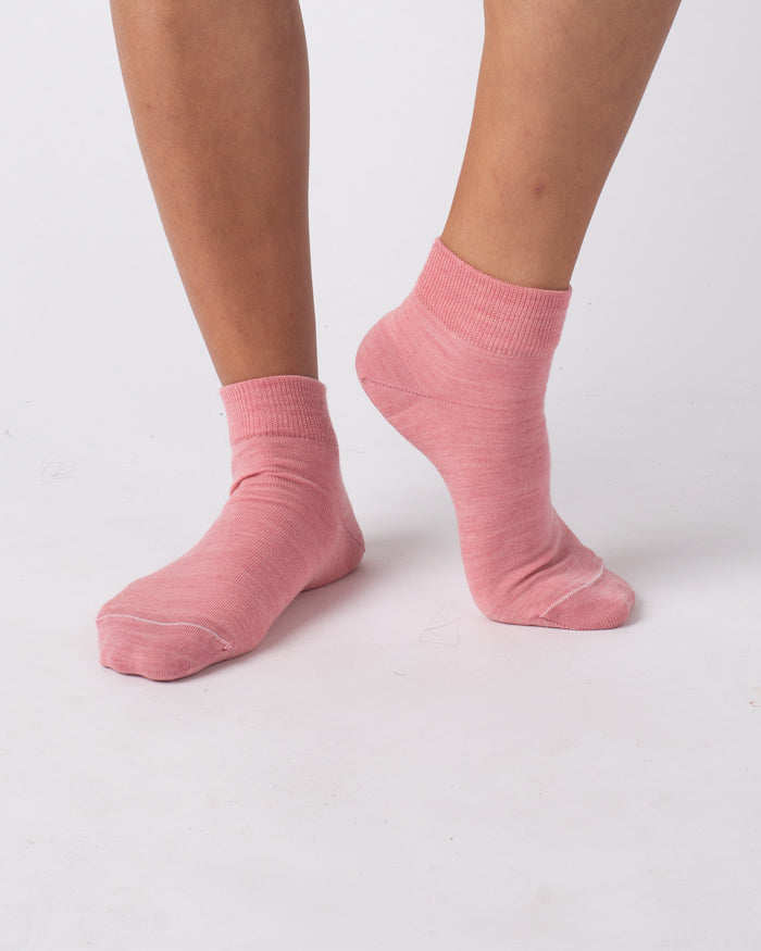 person wearing nisa merino ankle socks in pink